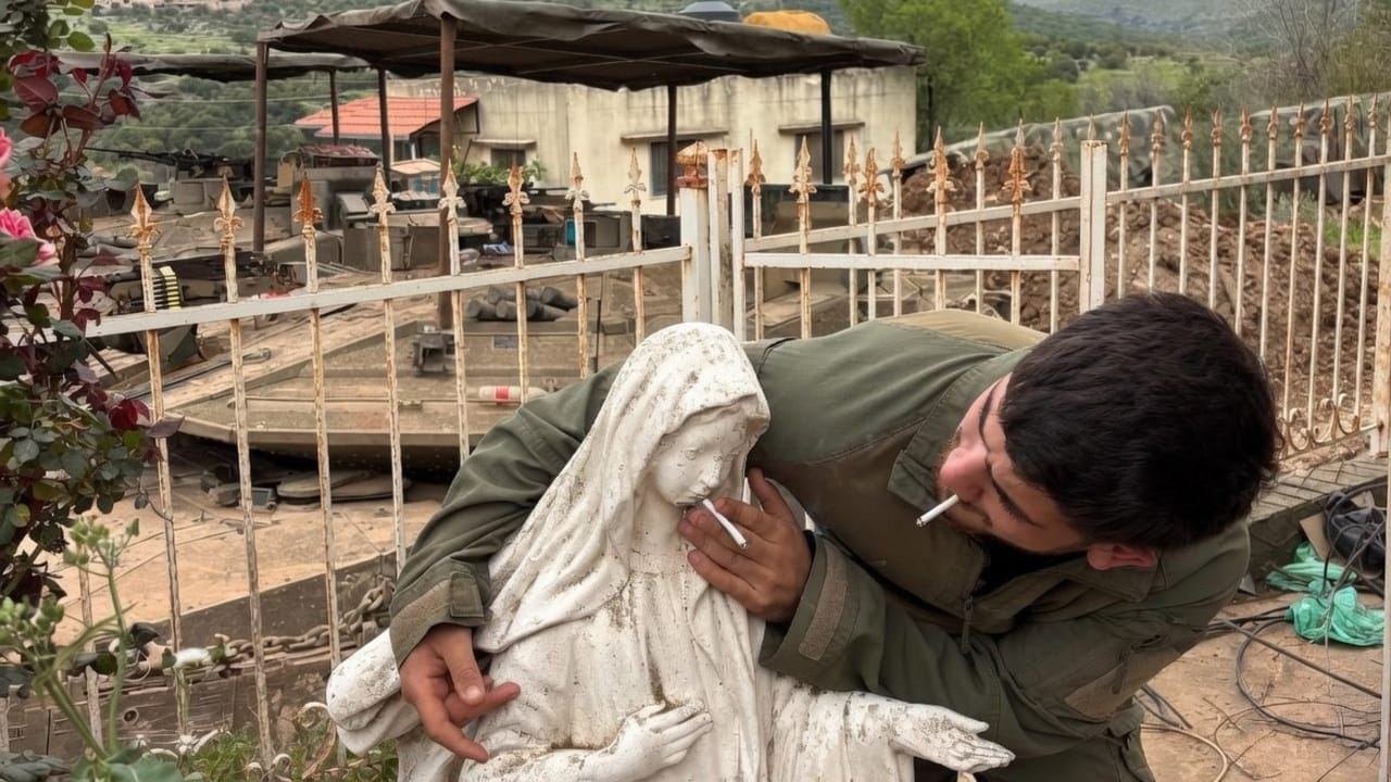 IDF soldier smoking cigarette with statue of Virgin Mary IDF soldier smoking cigarette with statue of Virgin Mary