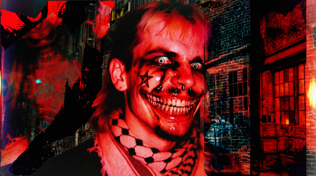 Creepypasta-style image of a man with a mullet wearing a keffiyeh with a wide surreal creepy grin. The entire image is corrupted and bathed in red colors.